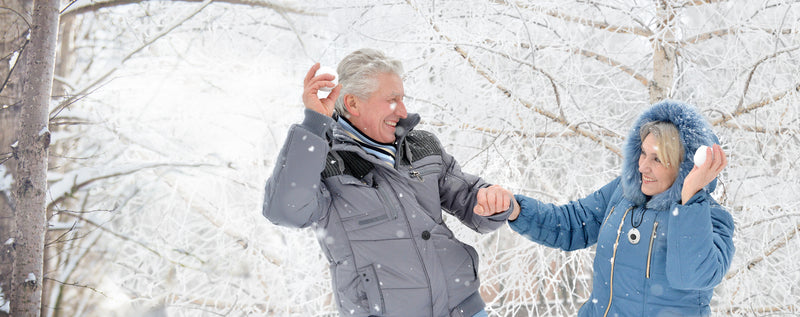 Senior couple fighting with snow